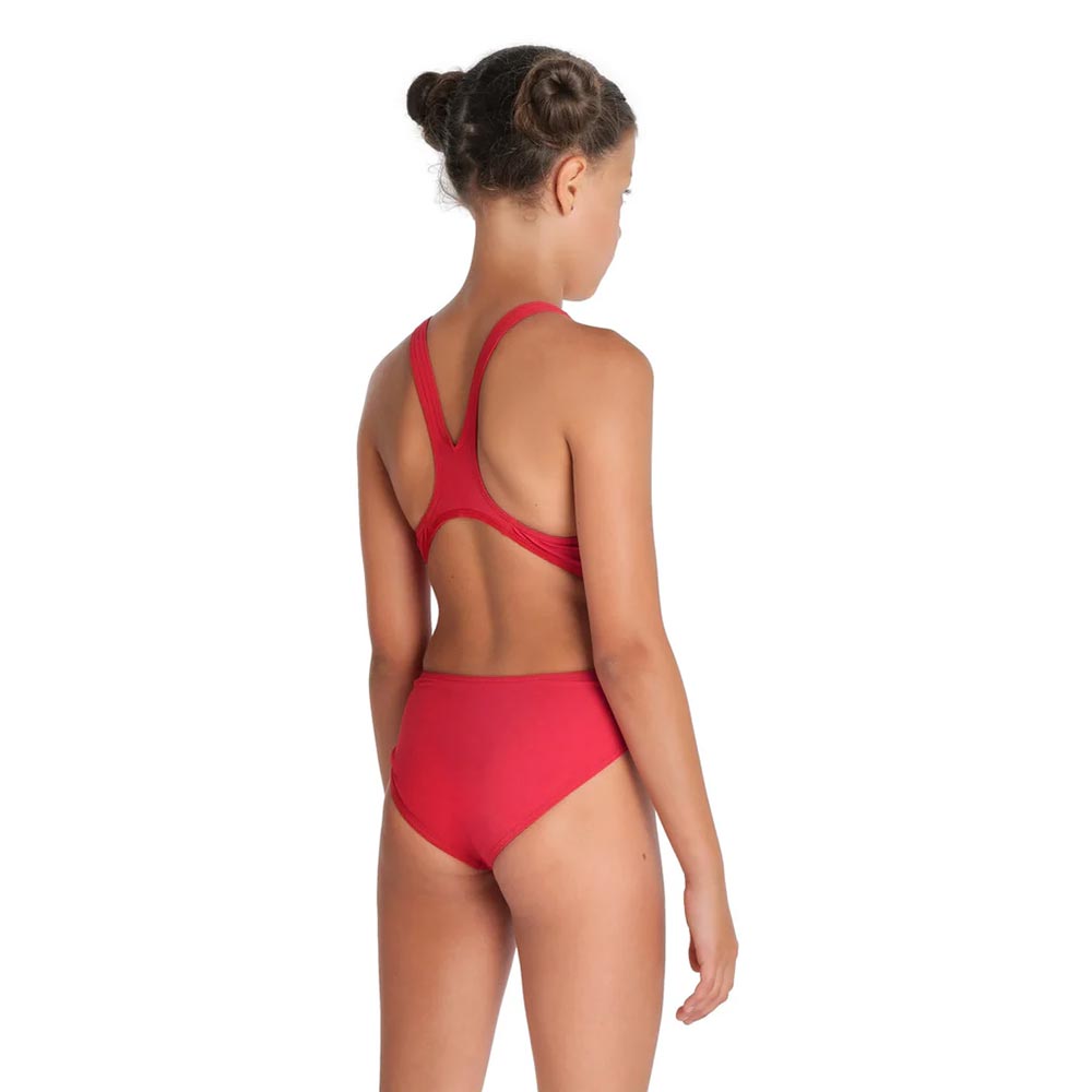 Back view of a girl wearing a red arena girls team swim tech swimsuit.
