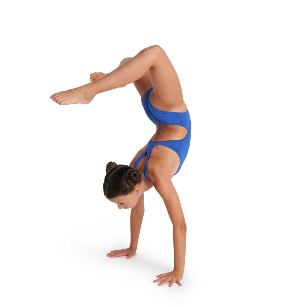 a young girl performing a handstand in an arena swimsuit.