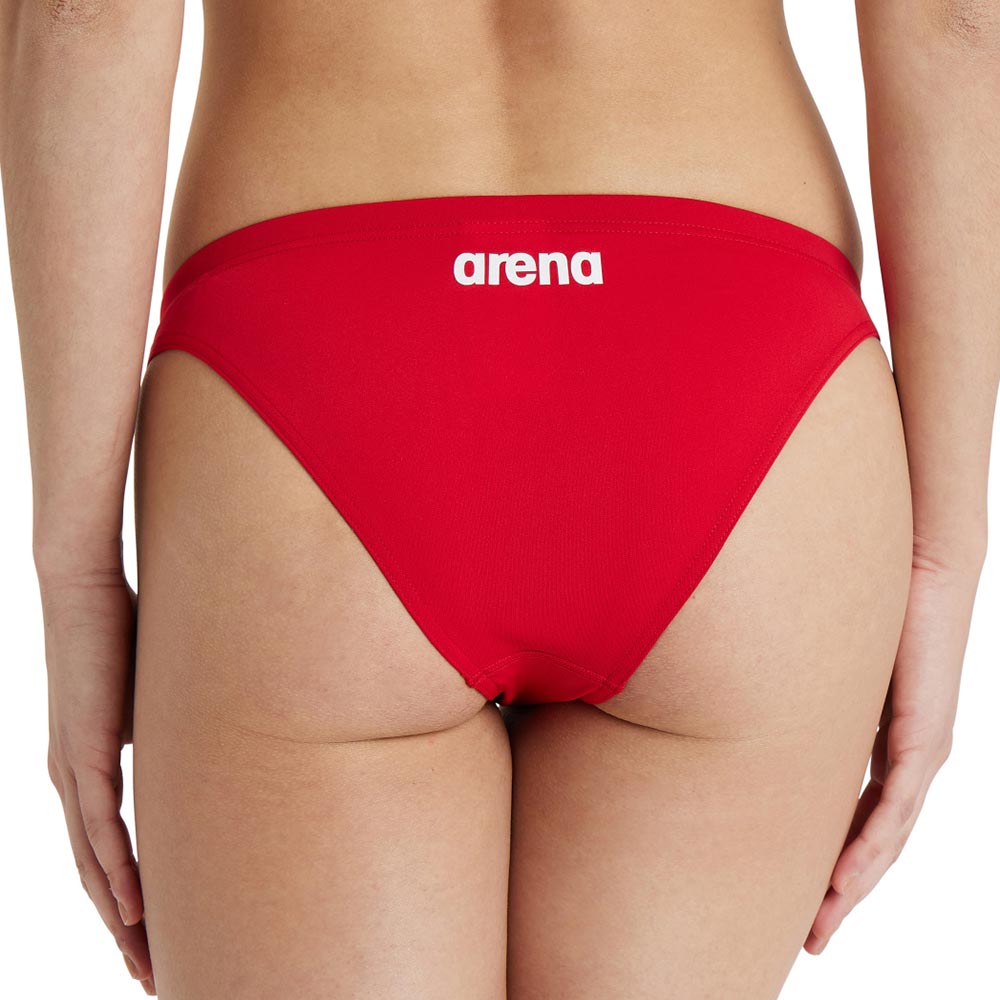 Back view of red arena womens team bikini bottoms with arena logo printed in white.