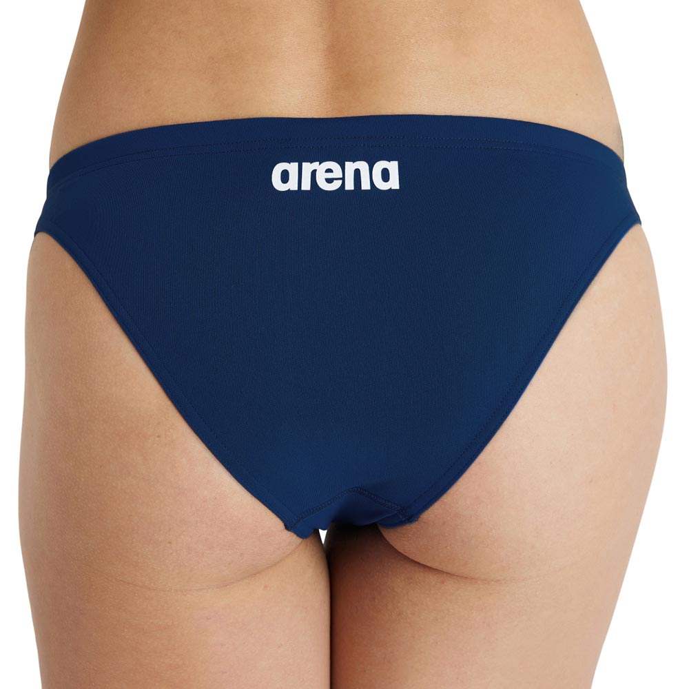 Back view of a navy arena womens team bikini bottom, with printed arena logo in white.