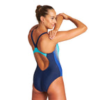 Back view of a woman wearing the arena threefold one piece swimsuit.