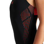 Close up of the black arena womens streak swimsuit with red detailing.