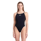 A woman wearing a black arena one piece swimsuit with the arena logo printed in white on the chest.