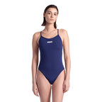 Front view of a woman wearing a navy arena one piece swimsuit. The arena logo is printed in white on the chest.
