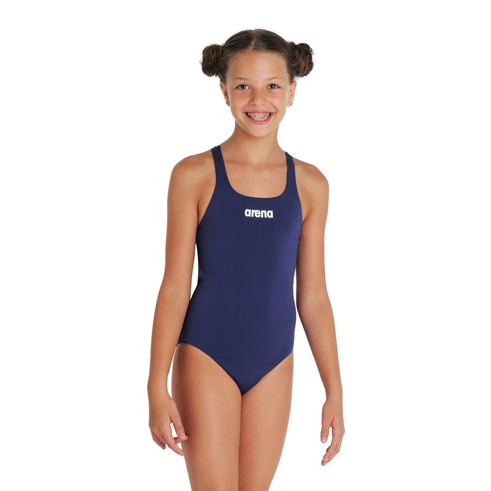 A young girl wearing a navy arena team swim pro swimsuit.