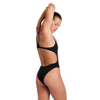 Woman wearing the open back arena womens team swimsuit in black.