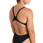 Close up of the support straps of the arena womens team swim tech swimsuit.
