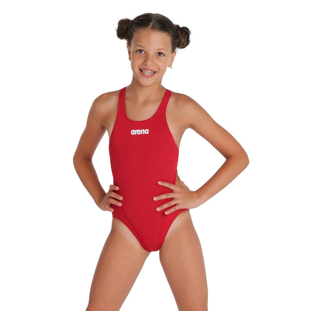 Girl wearing a red arena swimsuit with arena logo printed in white.