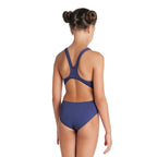 A girl wearing a navy arena swimsuit showing the back straps.