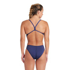 Back view of a woman wearing a navy arena one piece swimsuit.