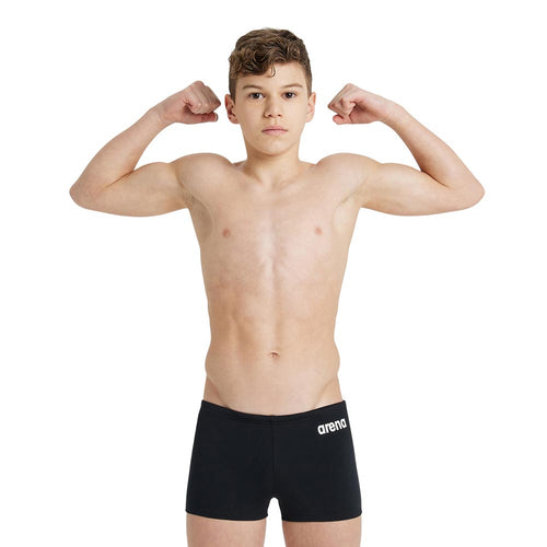 Boy wearing black arena boys team swim shorts.