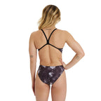 Back view of a woman wearing the arena womens chilling print one piece swimsuit.