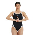 Woman wearing an arena icons swimsuit in black.