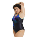 Woman wearing the arena flora plus one piece swimsuit.