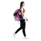 Arena One Go Printed Swim Backpack 45L: Pink and purple patterned backpack with mesh pockets, worn by a woman