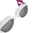 Close-up of white Arena The One Plus women's swim goggles with grey lenses and a pink strap.